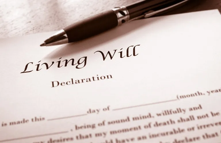 Close-up of a Living Will Declaration document with a black pen resting on top.