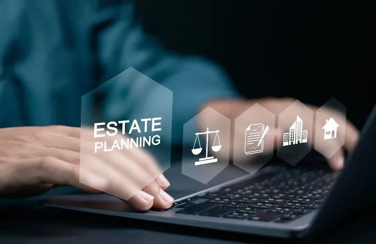 Hands typing on a laptop keyboard with digital icons and text "Estate Planning" displayed.